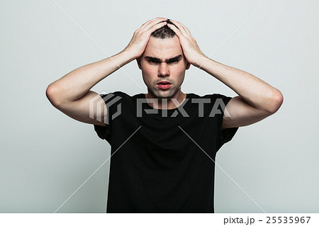 Worrying man posing at studio with arm on head Worrying man posing at studio with arm on head 25535967