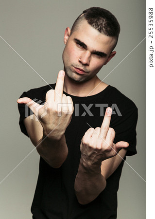 Man in black t-shirt showing middle fingers 25535988