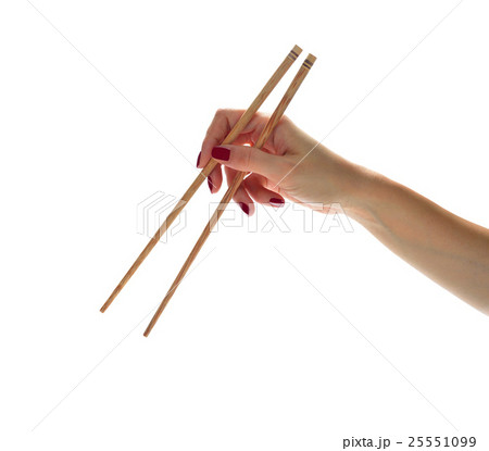 Woman hands holding chopsticks isolated on white Woman hands holding chopsticks isolated on white 25551099