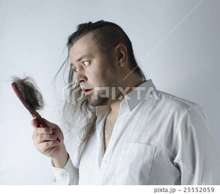 man looking at  hairbrush 25552059