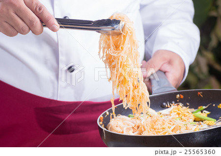 Chef fork over noodles by tongs Chef fork over noodles by tongs 25565360