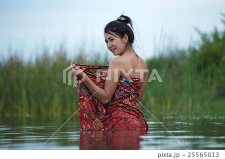 girl taking a shower in the river. 25565813