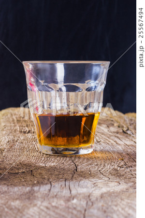 a glass of brandy on a wooden background with spac a glass of brandy on a wooden background with spac 25567494