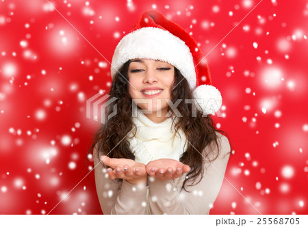 girl in santa hat portrait on red color background 25568705