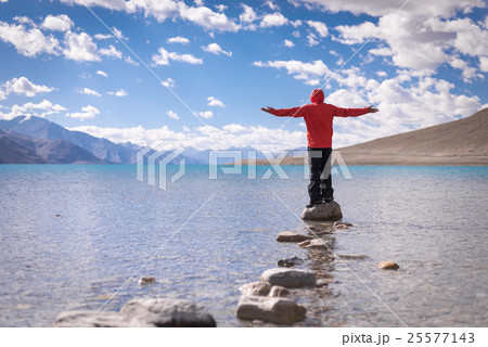 Traveler standing on the rock at Pangong Lake Traveler standing on the rock at Pangong Lake 25577143