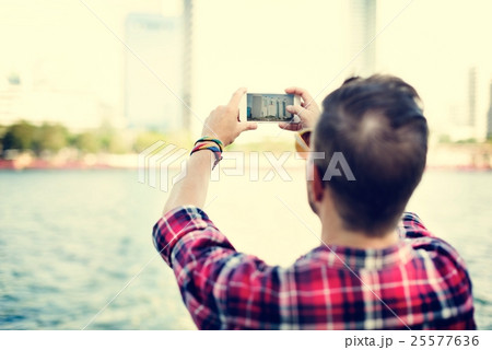 Young Man Taking Photo Smartphone Concept 25577636