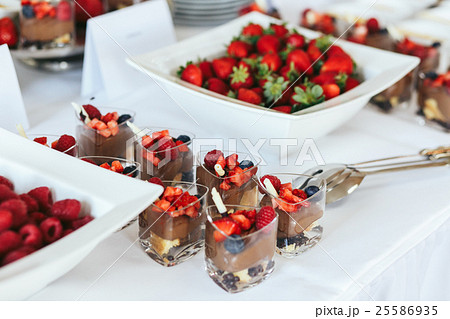 Chocolate desserts with strawberries stand  25586935