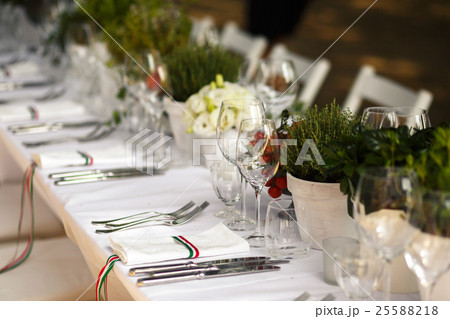 Sparkling forks and knives lie on white dinner Sparkling forks and knives lie on white dinner 25588218