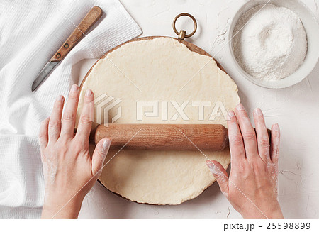 Women's hands roll the dough 25598899
