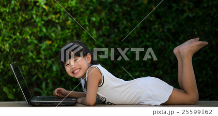 Happy little girl having fun play laptop 25599162
