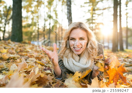 Beautiful blonde woman lying on the ground in Beautiful blonde woman lying on the ground in 25599247