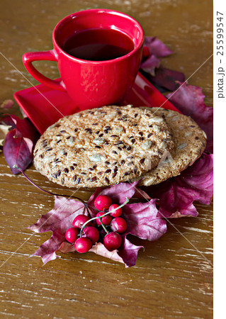 Red Cup with cookies, autumn leaves and berries 25599547