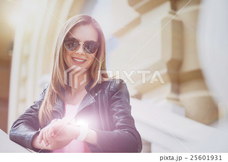 Positive woman using her smart watch 25601931