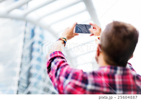 Young Man Taking Photo Smartphone Concept 25604887