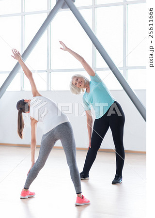 Positive enthusiastic woman doing bending Positive enthusiastic woman doing bending 25611666