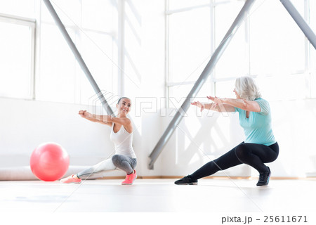 Good looking joyful women having aerobics classes Good looking joyful women having aerobics classes 25611671