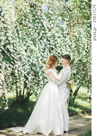 Happy wedding couple walking in a botanical park Happy wedding couple walking in a botanical park 25617174