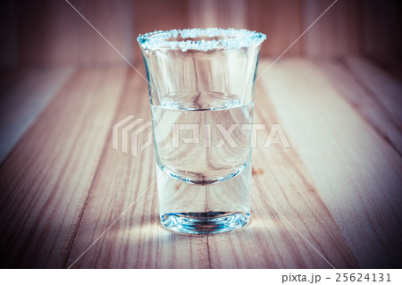 Vodka shot and salt sea on wooden table 25624131