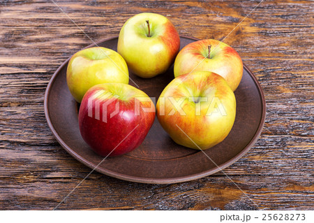 apple on a wooden table 25628273