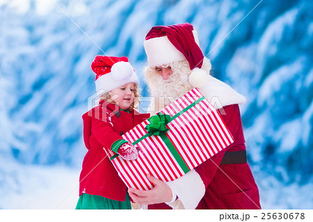 Kids and Santa with Christmas presents Kids and Santa with Christmas presents 25630678