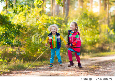 Kids playing in autumn park Kids playing in autumn park 25630679
