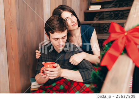 Smiling brunette hugging her boyfriend, close-up Smiling brunette hugging her boyfriend, close-up 25637809