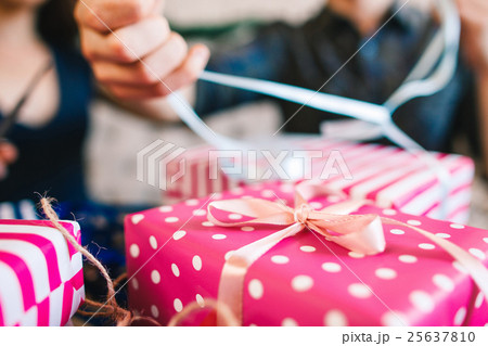 Closeup of pink gift box, Christmas gifts wrapping Closeup of pink gift box, Christmas gifts wrapping 25637810