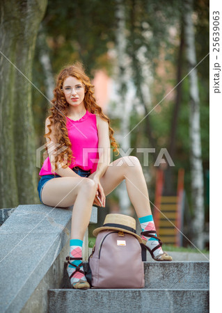 Portrait of a beautiful european woman sitting om 25639063