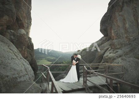 Gorgeous bride, groom kissing and hugging near the Gorgeous bride, groom kissing and hugging near the 25640693