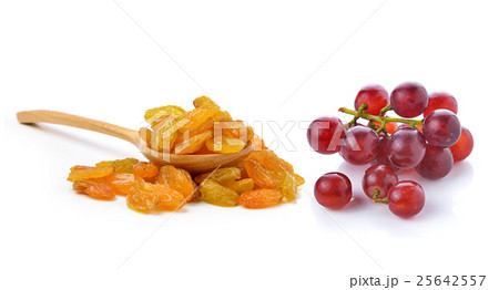Dried raisins in the wood spoon and grapes 25642557
