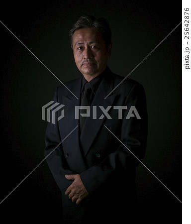 thai senior man wearing black suit sadness emotion ,portrait by 25642876