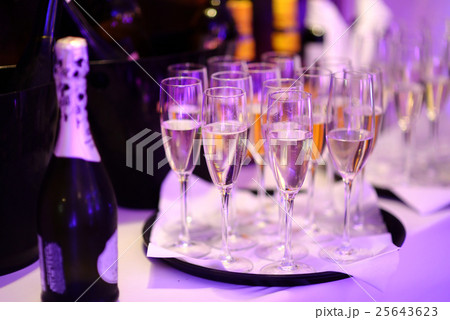 Lots of wine glasses during some festive event 25643623