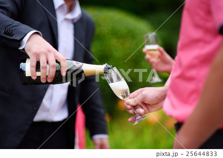 Pouring champagne into a glass Pouring champagne into a glass 25644833
