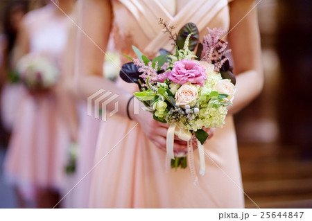 Row of bridesmaids with bouquets at wedding 25644847