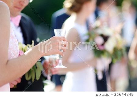 Woman holding a glass of champagne 25644849