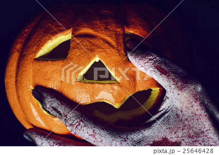 zombie or monster and carved pumpkin 25646428
