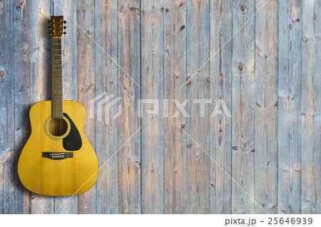 Acoustic guitar on wooden background texture 25646939