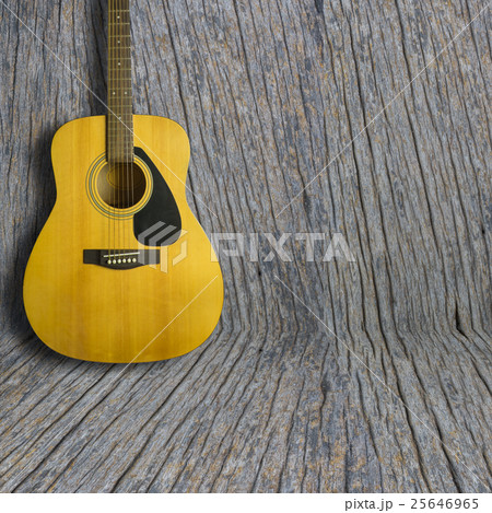 Acoustic guitar on wooden background texture 25646965