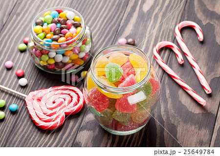 Colorful candies on wooden table 25649784