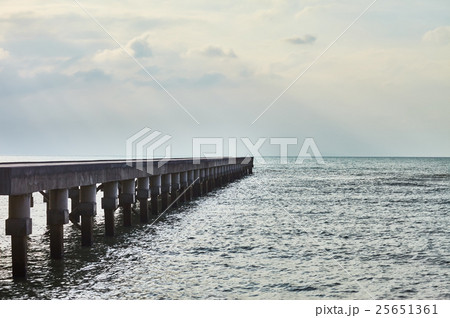 wooden pier with sun rays over sea wooden pier with sun rays over sea 25651361