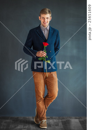 Full length portrait of happy handsome man with red rose Full length portrait of happy handsome man with red rose 25651609