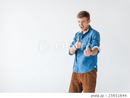 Portrait of happy smiling handsome man giving thumbs up sign 25651644