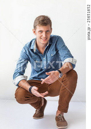 Handsome man sitting on the floor 25651652