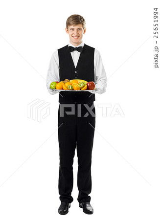 Young handsome waiter holding big tray full of fresh fruits 25651994