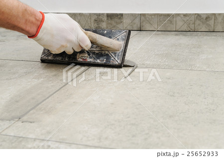Grouting ceramic tiles. 25652933