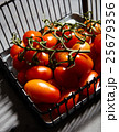 Fresh cherry tomatoes on branch in iron basket 25679356