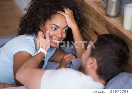 Sweet couple enjoying their honeymoon in bed 25679793