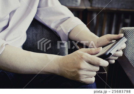 Man holding an electronic reader, reading Man holding an electronic reader, reading 25683798