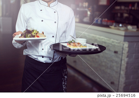 Waiters carrying plates with 25694516