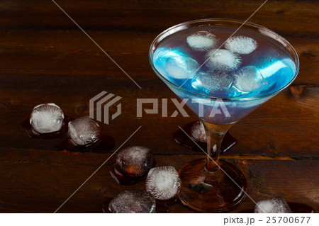 Iced blue cocktail on wooden background Iced blue cocktail on wooden background 25700677